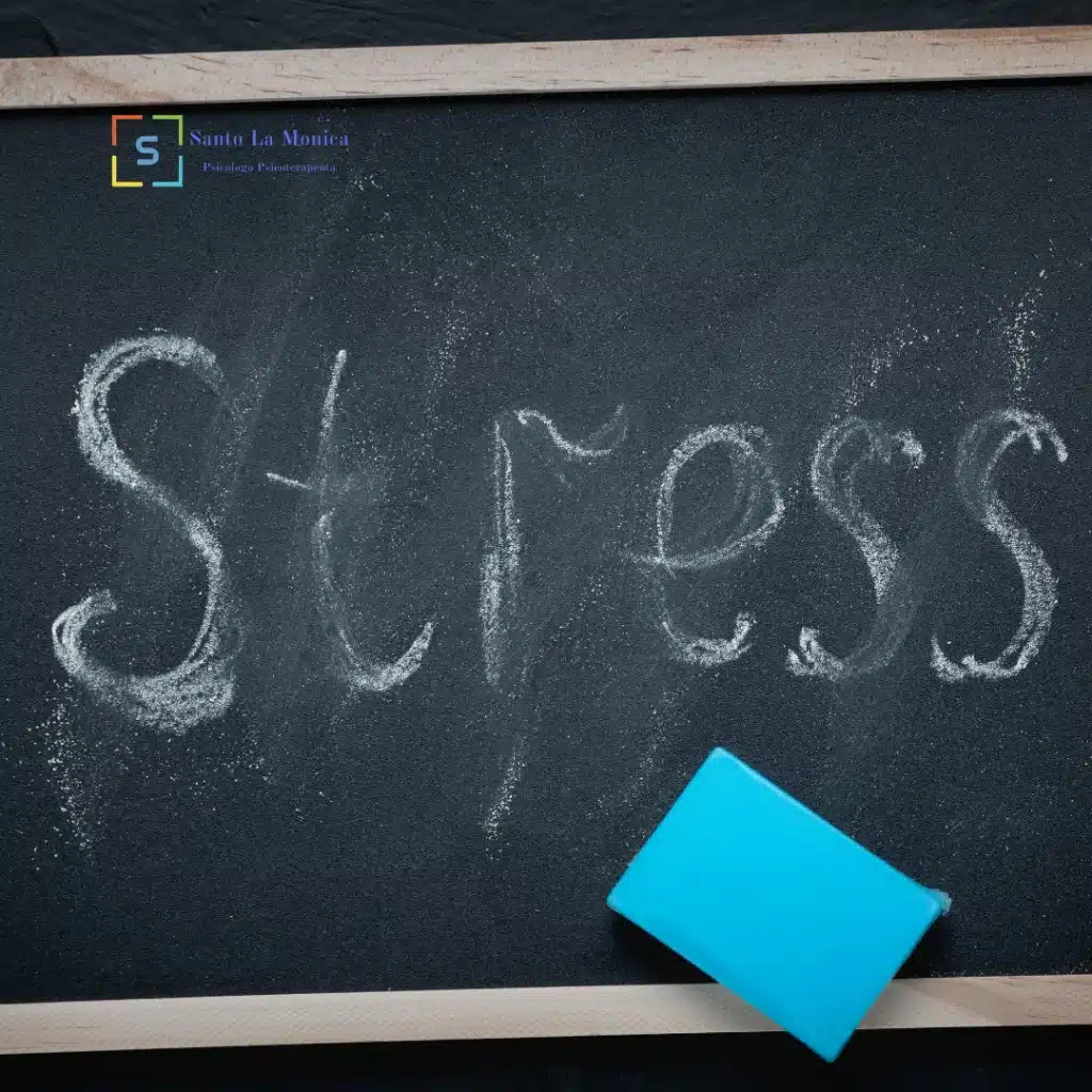 Lavagna con la scritta ‘Stress’ in gesso e una gomma blu appoggiata in basso a destra.